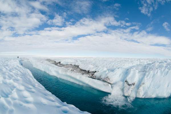 A waterfall empties into a meltwater channel on the ice sheet. 