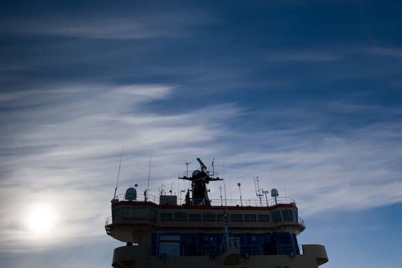 Cirrus clouds stream over the Oden's superstructure. 