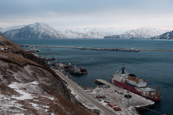 The icebreaker Healy shares Dutch Harbor's piers with container ships and fishing vessels.