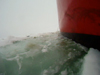 Broken chunks of sea ice scrape along the ship.